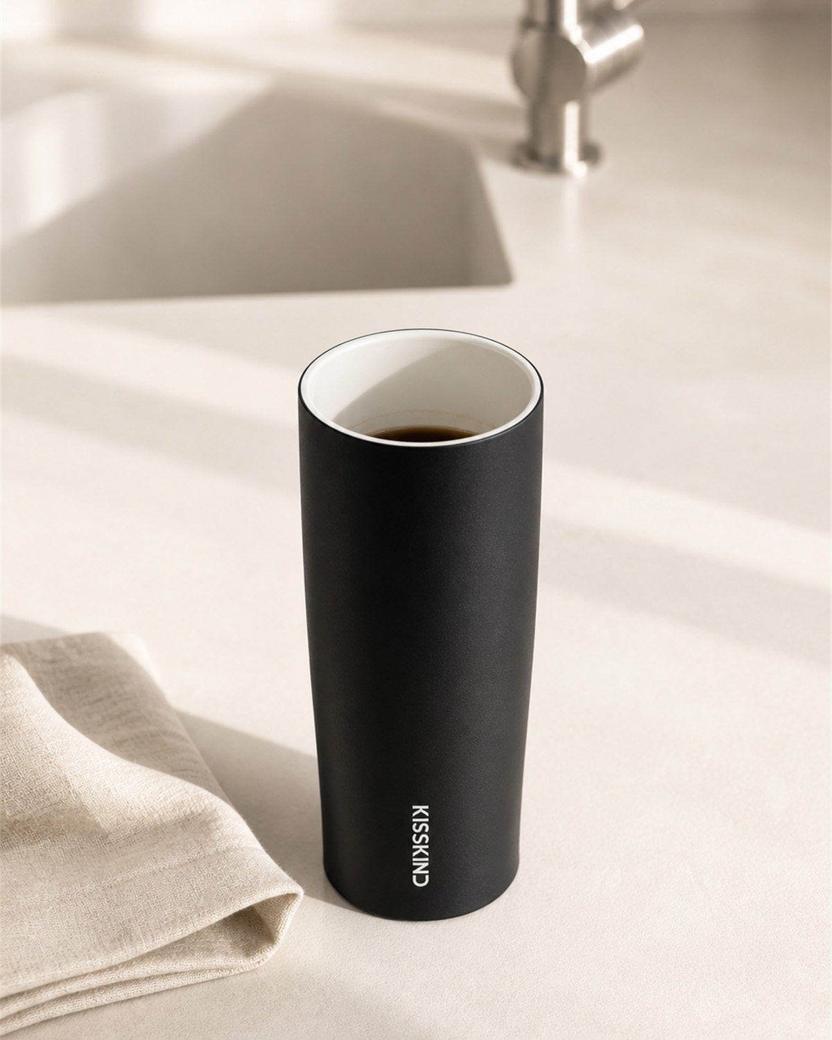 Open Kisskind tumbler showing its smooth white ceramic-coated interior